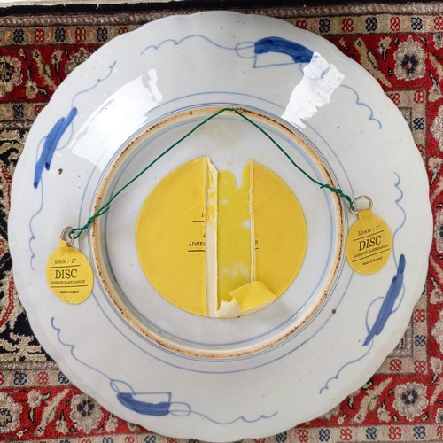 1068 - A Japanese Imari plate, 40 cm diameter, and a silk rug, 64 cm x 46 cm (2)