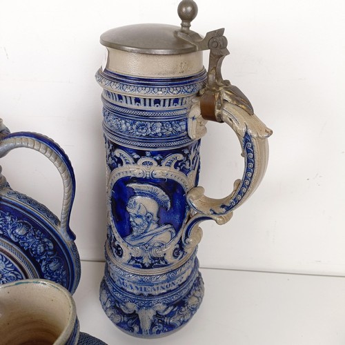 1076 - A German stoneware stein, decorated a portrait, 36 cm high, three similar ewers, a pair of beakers a... 