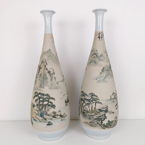 1079 - A pair of Chinese stoneware vases, decorated landscapes, 54 cm high