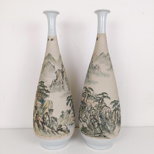 1079 - A pair of Chinese stoneware vases, decorated landscapes, 54 cm high