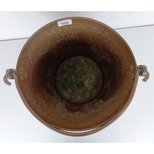 1086 - A Persian copper bucket, 60 cm high