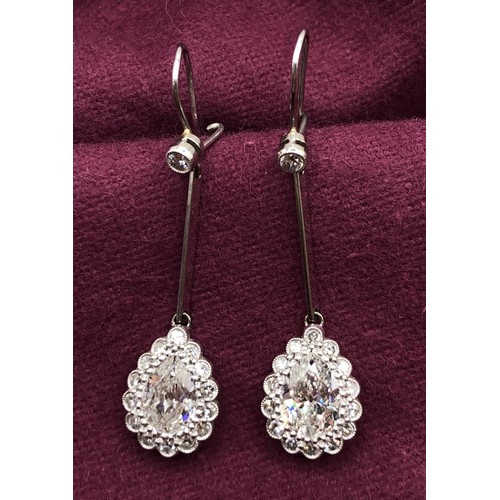 500 - A pair of early 20th century pear shaped diamond drop earrings