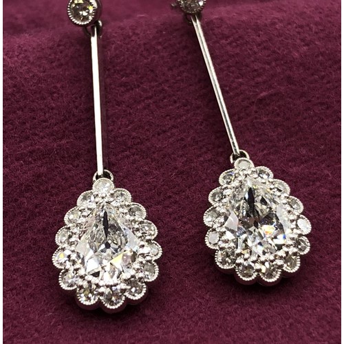 500 - A pair of early 20th century pear shaped diamond drop earrings