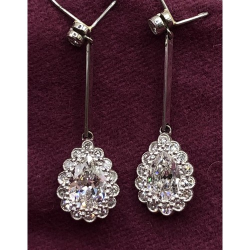 500 - A pair of early 20th century pear shaped diamond drop earrings