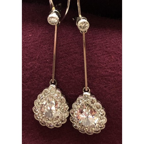 500 - A pair of early 20th century pear shaped diamond drop earrings