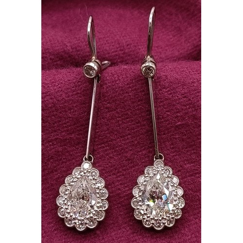 500 - A pair of early 20th century pear shaped diamond drop earrings