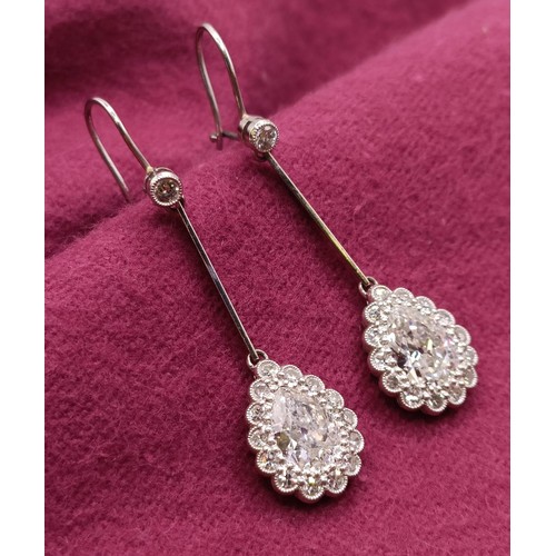 500 - A pair of early 20th century pear shaped diamond drop earrings