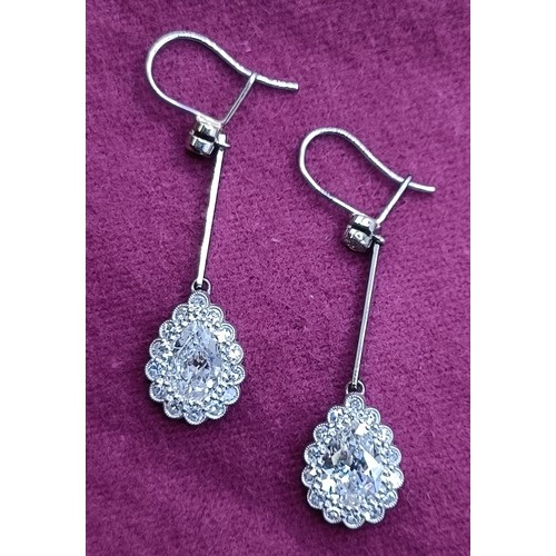 500 - A pair of early 20th century pear shaped diamond drop earrings