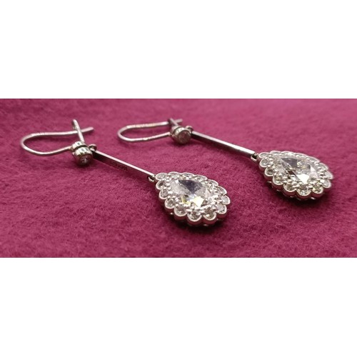 500 - A pair of early 20th century pear shaped diamond drop earrings