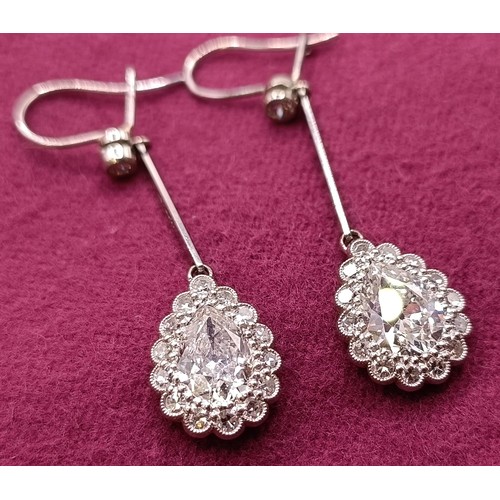 500 - A pair of early 20th century pear shaped diamond drop earrings