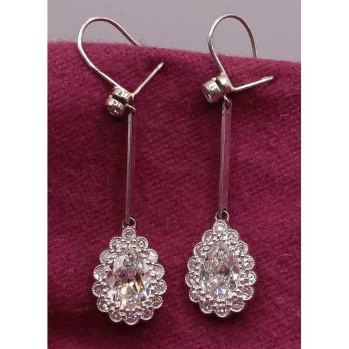 500 - A pair of early 20th century pear shaped diamond drop earrings