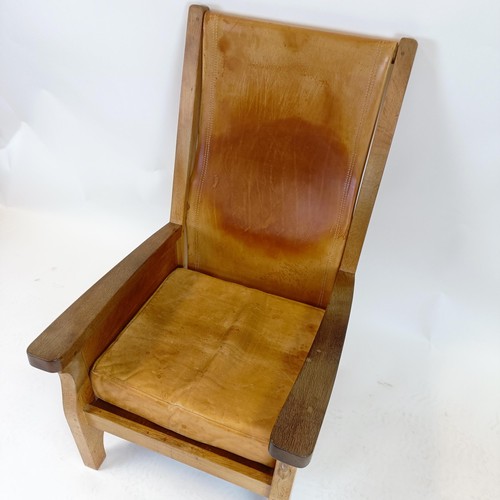 1204 - Robert Mouseman Thompson of Kilburn, an oak and leather library or smokers armchair, 62 cm wide