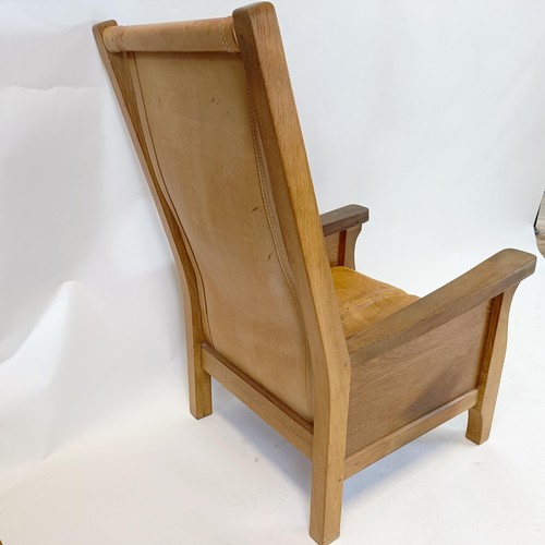 1204 - Robert Mouseman Thompson of Kilburn, an oak and leather library or smokers armchair, 62 cm wide