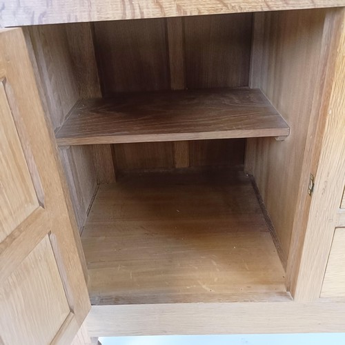 1215 - Robert Mouseman Thompson of Kilburn, a sideboard, with three central drawers, flanked by cupboard do... 