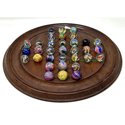 1143 - A 19th century solitaire board, with marbles, mostly coloured