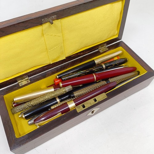 1129 - Assorted fountain and other pens, in a Victorian rosewood glove box, 24 cm wide