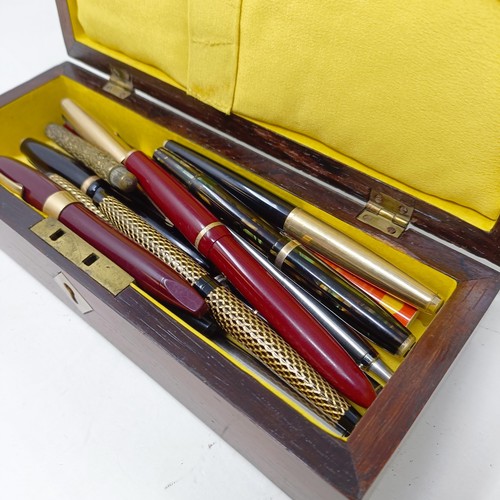 1129 - Assorted fountain and other pens, in a Victorian rosewood glove box, 24 cm wide