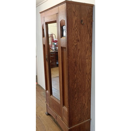 1240 - An Arts and Crafts single wardrobe, with a mirrored door, 195 cm high, 95 cm wide