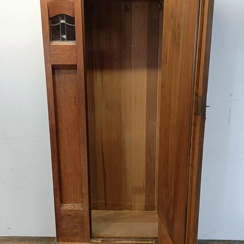 1240 - An Arts and Crafts single wardrobe, with a mirrored door, 195 cm high, 95 cm wide