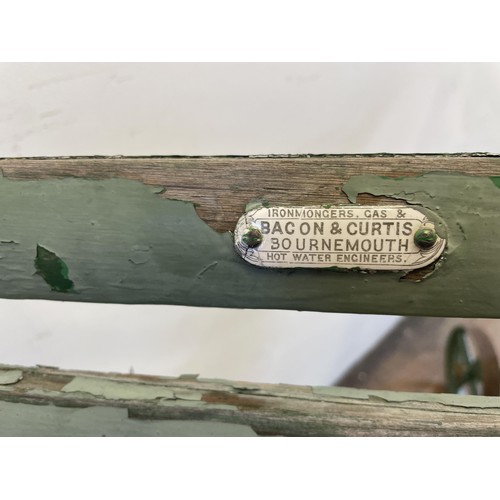 1279 - A pair of Country House green painted garden chairs, by Bacon & Curtis, Bournemouth, with metal ... 