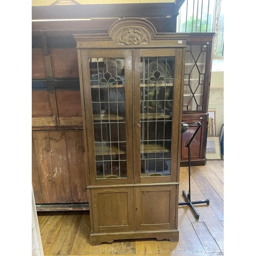 1287 - An oak bookcase, with leaded glazed doors, 193 cm high, 85 cm wide, and a G-plan wardrobe (2)