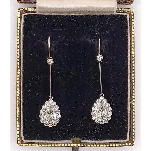 500 - A pair of early 20th century pear shaped diamond drop earrings