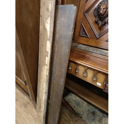 1305 - A 19th century walnut bookcase on cupboard, having open shelves above a pair of panel door carved li... 