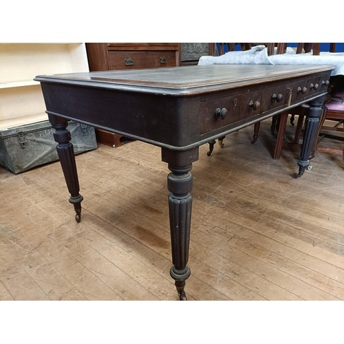 1319 - A 19th century mahogany library table, having three drawers, on tapering reeded legs, 135 cm wide