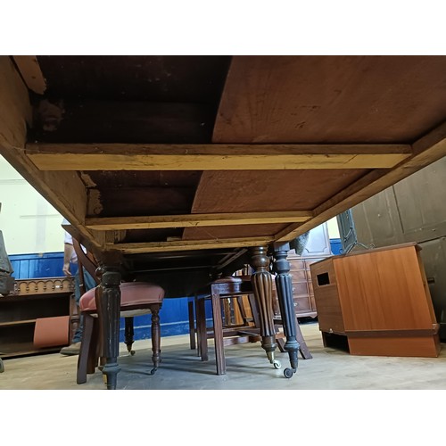 1319 - A 19th century mahogany library table, having three drawers, on tapering reeded legs, 135 cm wide