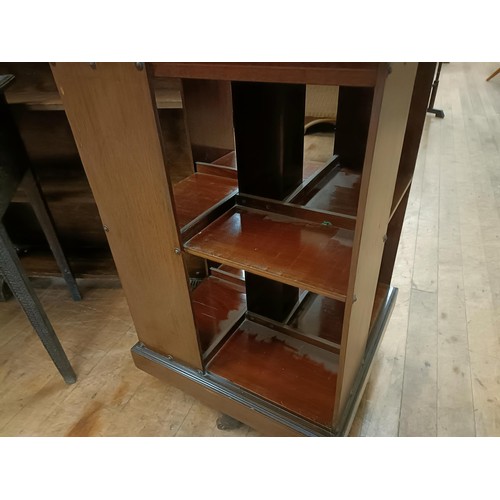 1335 - A mahogany revolving bookcase, 51 cm wide, a bookcase, 92 cm wide, and a side table (3)