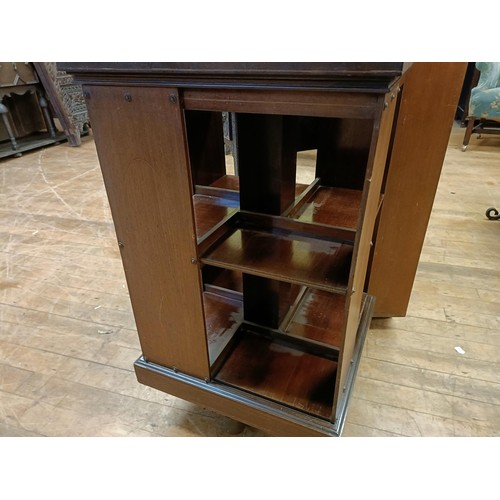 1335 - A mahogany revolving bookcase, 51 cm wide, a bookcase, 92 cm wide, and a side table (3)