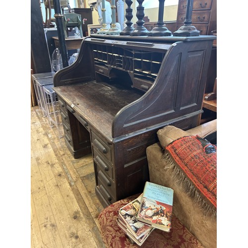 1262 - A large oak tambour fronted desk, 127 cm high, 132 cm wide