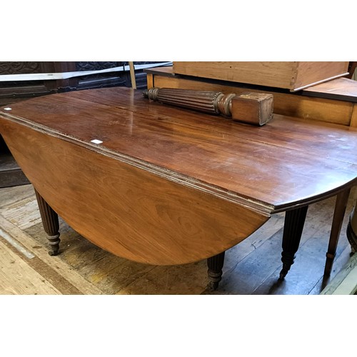 1278 - A 19th century mahogany extending dining table, with drop leaves, on tapering reeded legs to casters... 