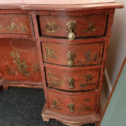 1293 - An early 20th century kneehole desk, with red chinoiserie style decoration, having seven drawers, 13... 