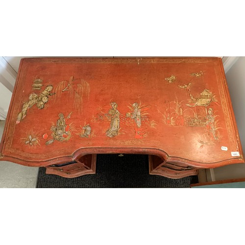 1293 - An early 20th century kneehole desk, with red chinoiserie style decoration, having seven drawers, 13... 