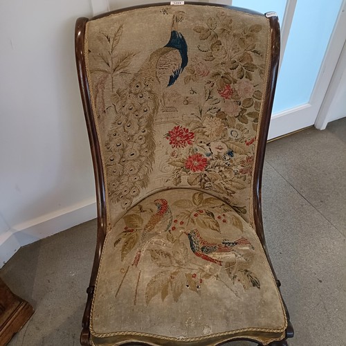 1294 - An early Victorian rosewood chair, with a needlework back and seat