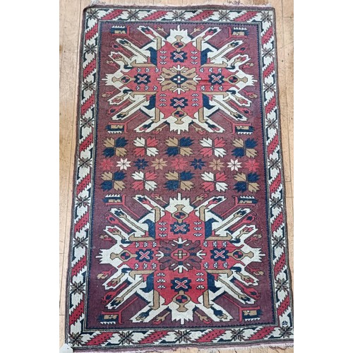 1313 - A red ground rug, 182 x 105 cm