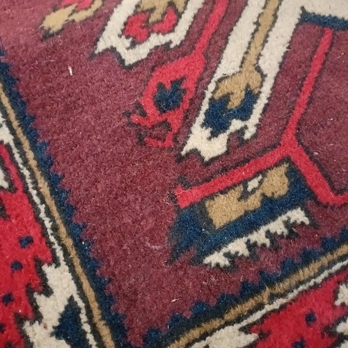 1313 - A red ground rug, 182 x 105 cm