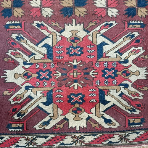 1313 - A red ground rug, 182 x 105 cm