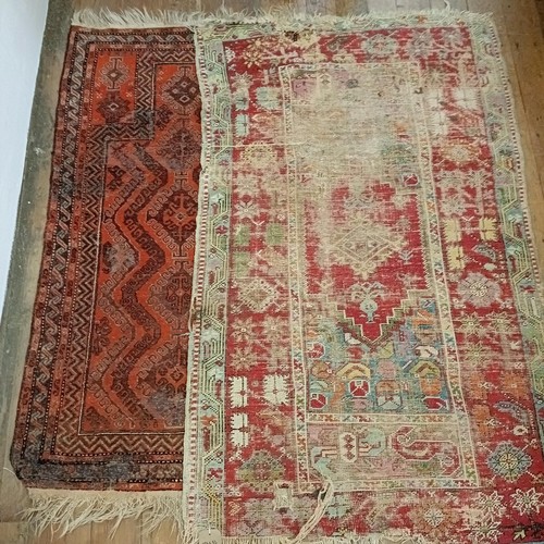 1241 - A red ground rug, 177 x 122 cm, another, 162 x 91 cm, and another, 202 x 125 cm, and a red ground ca... 