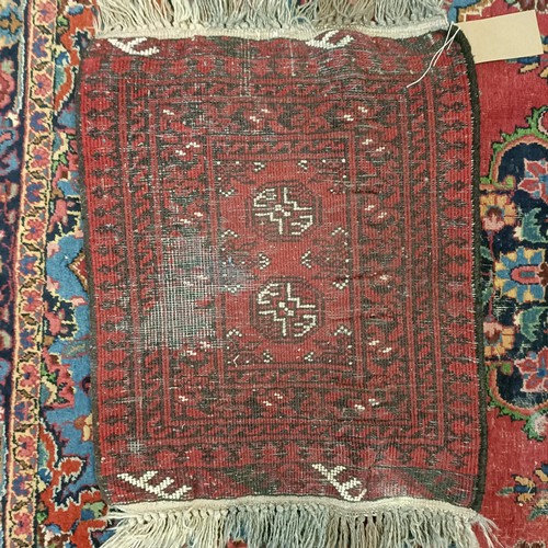 1245 - A red ground rug, 210 x 116 cm, a prayer mat, 61 x 52 cm, and another, 61 x 44 cm (3)