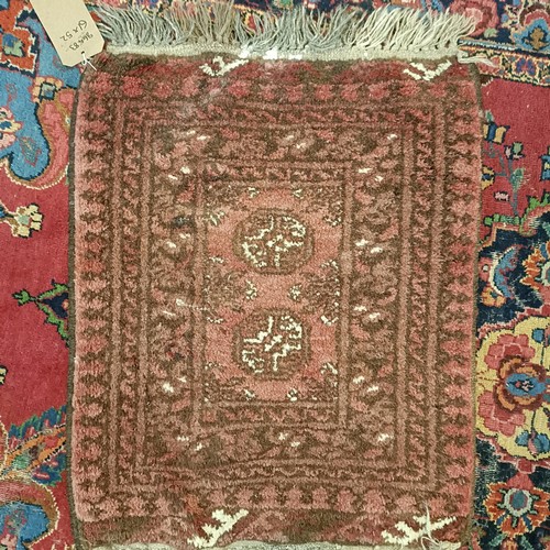 1245 - A red ground rug, 210 x 116 cm, a prayer mat, 61 x 52 cm, and another, 61 x 44 cm (3)