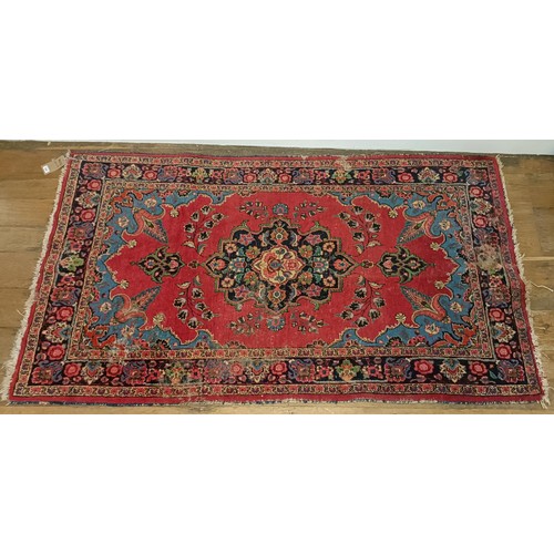 1245 - A red ground rug, 210 x 116 cm, a prayer mat, 61 x 52 cm, and another, 61 x 44 cm (3)