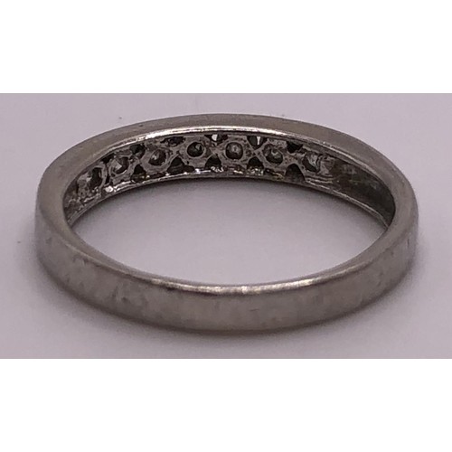 823 - An 18ct white gold, and diamond half eternity ring