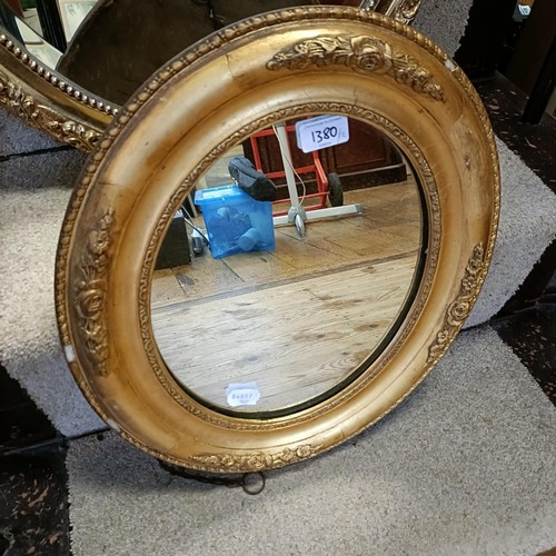 1380 - A gilt framed oval wall mirror, 45 x 40 cm, and another, 68 x 52 cm