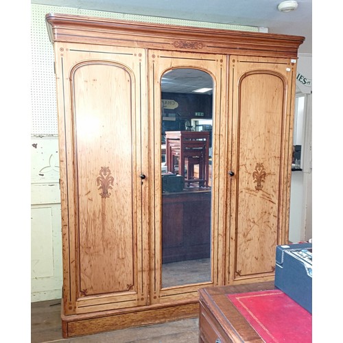 1242 - A Victorian pine triple wardrobe, with a central mirrored door and stencilled decoration, 180 cm wid... 