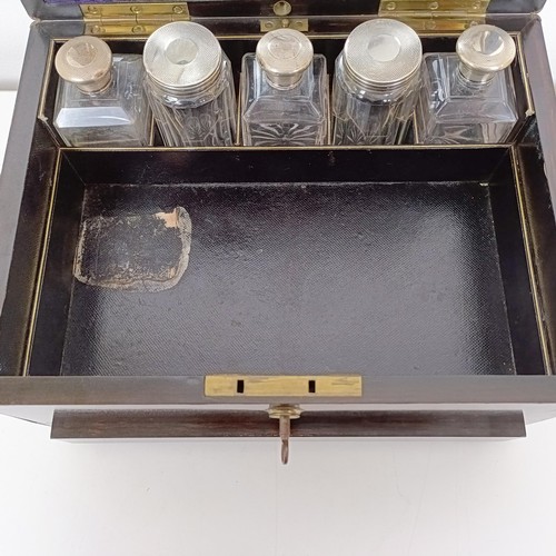 190 - A 19th century coromandel dressing box, the hinged top to reveal a mirror and various silver top bot... 