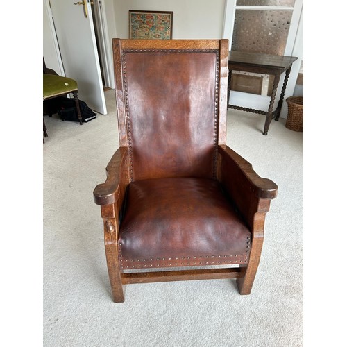 1225 - Robert Mouseman Thompson of Kilburn, a 1920s adzed oak library or smoking chair, having a rare panel... 