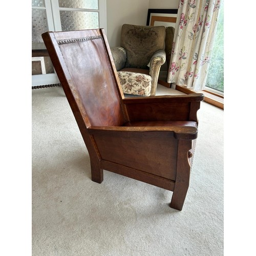 1225 - Robert Mouseman Thompson of Kilburn, a 1920s adzed oak library or smoking chair, having a rare panel... 