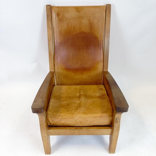 968 - Robert Mouseman Thompson of Kilburn, an oak and leather library or smokers armchair, 62 cm wide